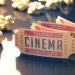 Entry ticket to the cinema with popcorn around. Clipping path included.