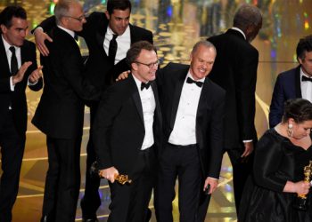 Tom McCarthy, center left, and Michael Keaton, center right, accept the award for best picture for 