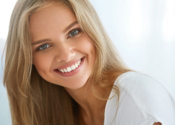 Beautiful Woman Smiling. Portrait Of Attractive Happy Healthy Girl With Perfect Smile, White Teeth, Blonde Hair And Fresh Face Smiling Indoors. Beauty And Health Concept. High Resolution Image