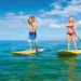 Couple Stand Up Paddle Surfing In Hawaii, Beautiful Tropical Ocean, Active Beach Lifestyle