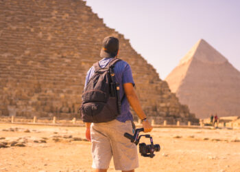 A young photographer at the pyramid of Cheops the largest pyramid. The pyramids of Giza the oldest funerary monument in the world. In the city of Cairo, Egypt